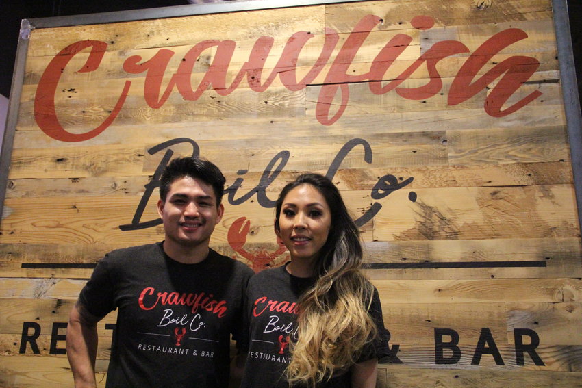 Owner Khiem Nguyen, 27, left, and manager Angel Byun, 30, stand March 18 at Crawfish Boil Co. restaurant and bar in The Streets at SouthGlenn outdoor mall.